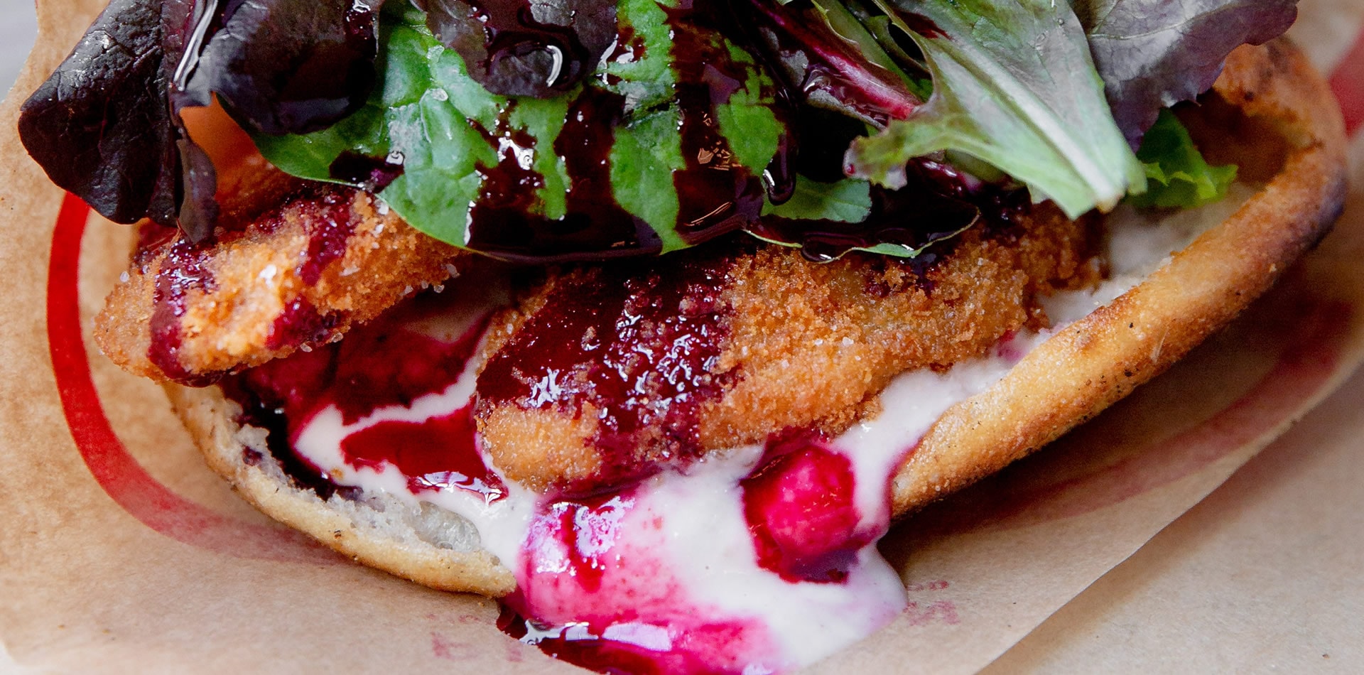 A close-up shot of PITTABUN's Fish and Beets bun