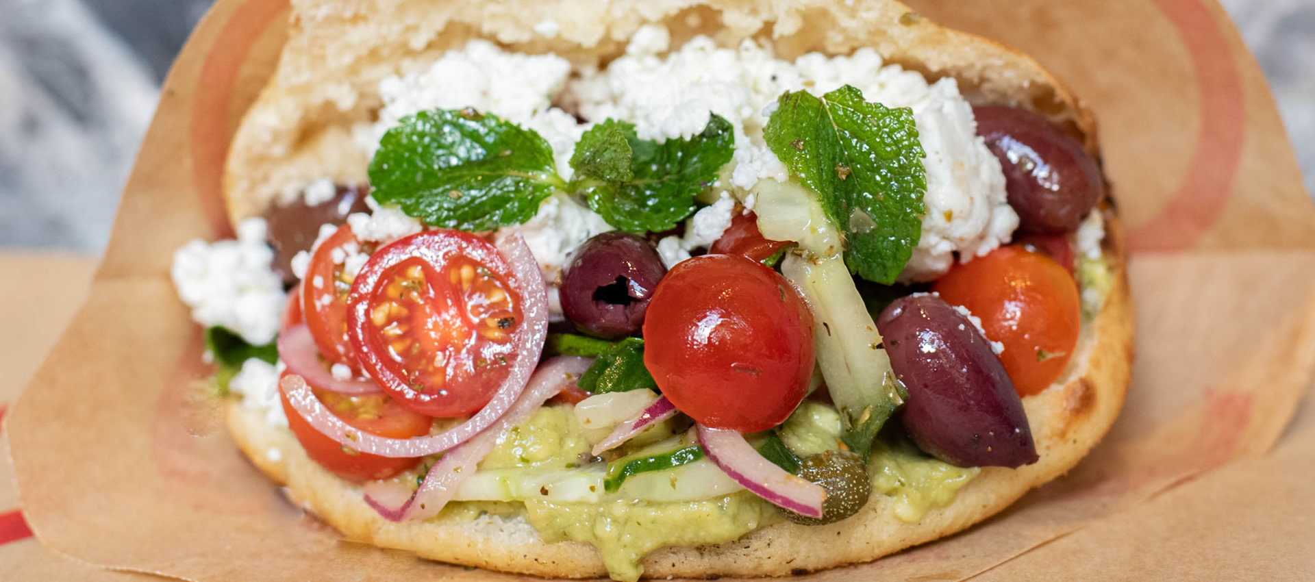 Our vegan greecamole PITTABUN with homemade chunky guacamole, Greek salad, optional feta