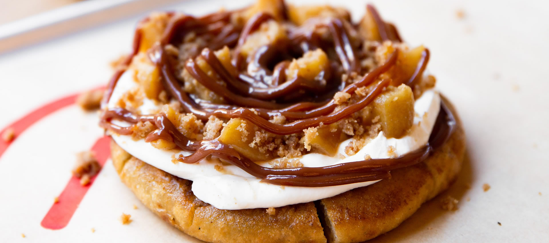 Our apple crumble sweet PITTABUN with caramelized apples, cinnamon crumble, salted caramel sauce
